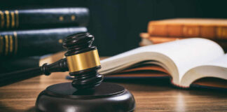 Judge's gavel on desk with open law book