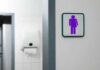 Virginia Board Pick Ignites Bathroom Debate Unisex restroom sign on a white wall