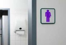 Virginia Board Pick Ignites Bathroom Debate Unisex restroom sign on a white wall