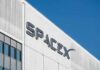SpaceX logo on a white industrial building facade