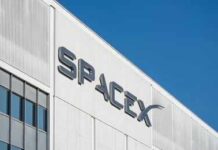 SpaceX logo on a white industrial building facade