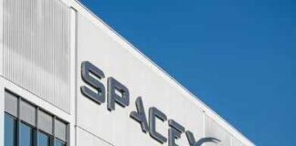 SpaceX Cash Boom—But What’s Real? SpaceX logo on a white industrial building facade