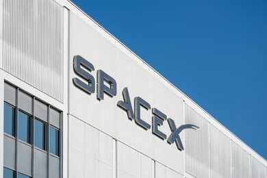 SpaceX logo on a white industrial building facade