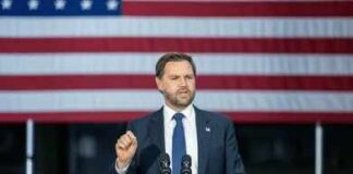 A senator passionately speaking at a press conference with raised fists