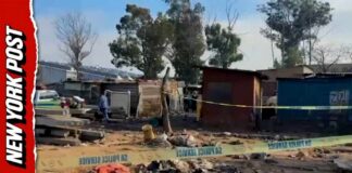 Bodies removed in Johannesburg after a dozen people killed by attackers in late-night mass shooting