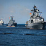 A fleet of military ships sailing in the ocean