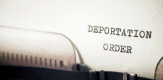 Risky Power Play: Women Sent Into Warzone? Close-up of a typewriter with a paper showing the words DEPORTATION ORDER