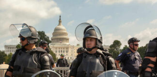 DEI Playbook Reloaded — Now Aiming At Protest Law enforcement officers in riot gear near the Capitol building