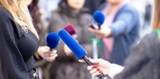 Media Circus Threatens Kirk Murder Trial Reporters holding microphones during an interview