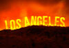 A dramatic landscape featuring the words Los Angeles against an orange sky, suggesting a fire or sunset.