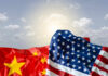 Can America Catch China Now? Crumpled flags of the United States and China against a cloudy sky