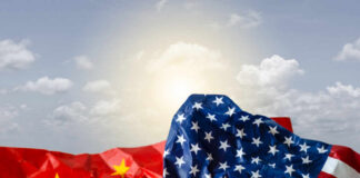Can America Catch China Now? Crumpled flags of the United States and China against a cloudy sky