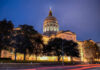 State capitol building illuminated at night with a prominent dome