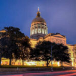 State capitol building illuminated at night with a prominent dome