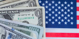 Illegal Tax Bombshell Hits Trump Plan Various denominations of US dollar bills on an American flag background
