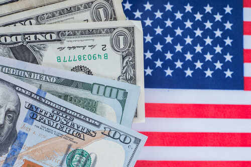 Dollars.,Money,On,The,Background,Of,The,Usa,Flag.,Finance Various denominations of US dollar bills on an American flag background