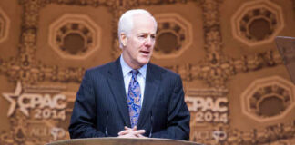 Texas Shock: Cornyn Boosts Paxton Foil A politician speaking at the Conservative Political Action Conference