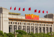 U.S. Scholar Vanishes Into China’s Shadows Facade of the National Museum of China adorned with red flags and decorative elements