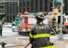 FDNY Truck Kills Woman — What Went Wrong? Firefighter in FDNY uniform overseeing emergency response at a city intersection