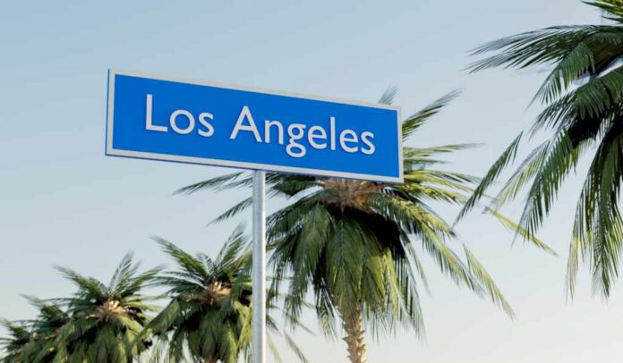Welcoming,Road,Sign,Of,Los,Angeles Sign indicating Los Angeles with palm trees in the background