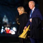 Joe and Jill Biden walking together outdoors at night