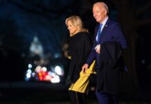 Memoir Snub Triggers Political Meltdown Joe and Jill Biden walking together outdoors at night