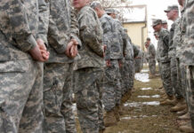 Top ISIS Leader Eliminated in Secret U.S.–Nigeria Raid A line of soldiers in military uniforms standing outdoors in formation