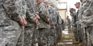Top ISIS Leader Eliminated in Secret U.S.–Nigeria Raid A line of soldiers in military uniforms standing outdoors in formation