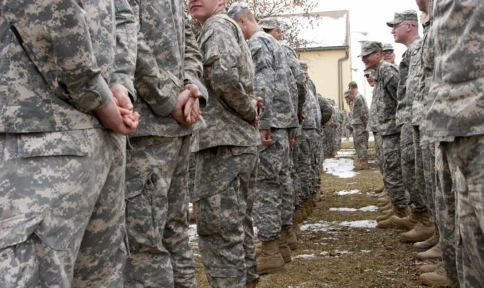 shutterstock_25208464 A line of soldiers in military uniforms standing outdoors in formation