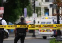 Satanic Ritual Claim Sparks Restaurant Rescue Police officers near a crime scene marked by caution tape