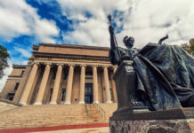 Columbia’s Merit Debate Just Got Hot Bronze seated statue before a neoclassical building with tall columns