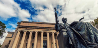 Columbia’s Merit Debate Just Got Hot Bronze seated statue before a neoclassical building with tall columns