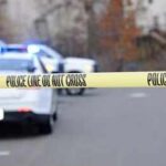 Deadly Wisconsin Storm Capsizes Family Boat Police tape cordons off a street with patrol cars in the background