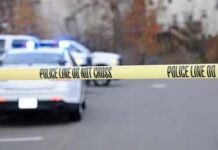 Deadly Wisconsin Storm Capsizes Family Boat Police tape cordons off a street with patrol cars in the background