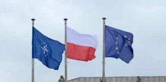 Intelligence Flags Possible Russian Border Provocation Flags of Finland and NATO waving in the wind against a clear blue sky