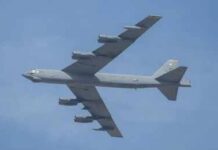 Military bomber aircraft flying against a blue sky