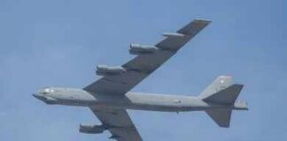 Military bomber aircraft flying against a blue sky