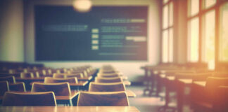 Newsom Withholds Billions From Schools Empty classroom with wooden desks and chairs, illuminated by natural light