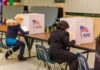 China Scooped Up Millions Of Voter Files Voters seated at booths filling out ballots in a polling place