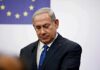 Could Israel Split The Democratic Party? man in suit at podium with EU flag in background