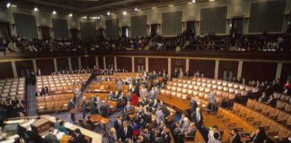 Ban or Bust? Dems Balk at Weak Fix Legislative chamber with members gathering on the floor