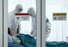 Senator’s Shocking Claim Rattles CDC Healthcare workers in hazmat suits treat a patient in a quarantine room