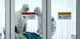 Senator’s Shocking Claim Rattles CDC Healthcare workers in hazmat suits treat a patient in a quarantine room