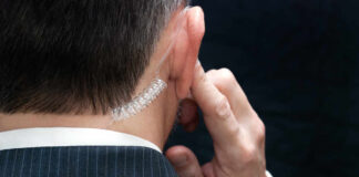 Butler Shooting Report Reveals Major Lapses Close-up of a man in a suit with an earpiece, indicating a security role