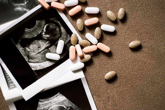shutterstock_1899589552 Ultrasound images with assorted pills on a brown surface