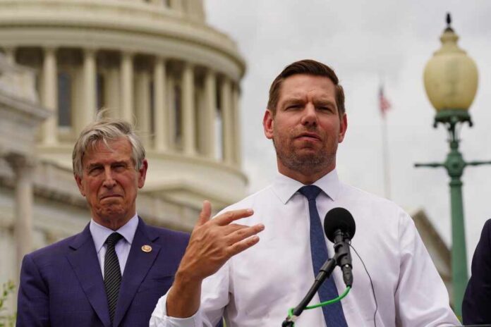 Washington,,Dc,,July,28,,2022:,Rep.,Eric,Swalwell,(d-ca) Two men at a press conference outside the Capitol building, one speaking into a microphone