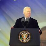 Biden Pardon Hits Wall In Congress man at presidential podium delivering a speech