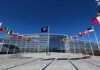 Spy Scare Inside NATO HQ NATO headquarters with member flags in front under a clear blue sky