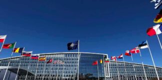 Spy Scare Inside NATO HQ NATO headquarters with member flags in front under a clear blue sky