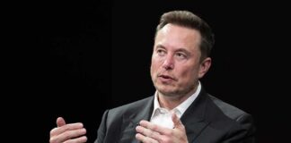 Economist Clash: Musk Flips The Label man in a suit speaking with hand gestures